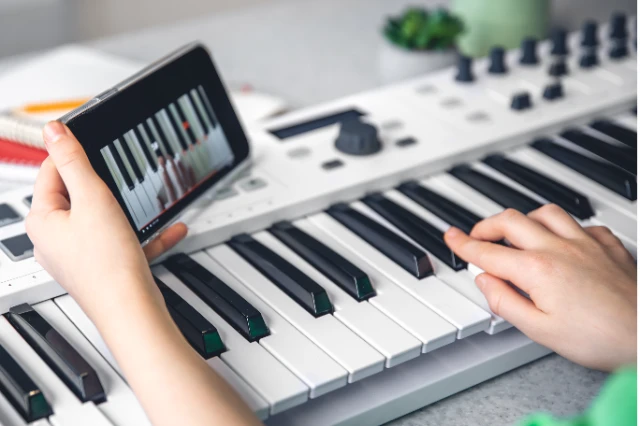 1775630634774-child-learns-play-piano-with-smartphone-online-music-lesson
